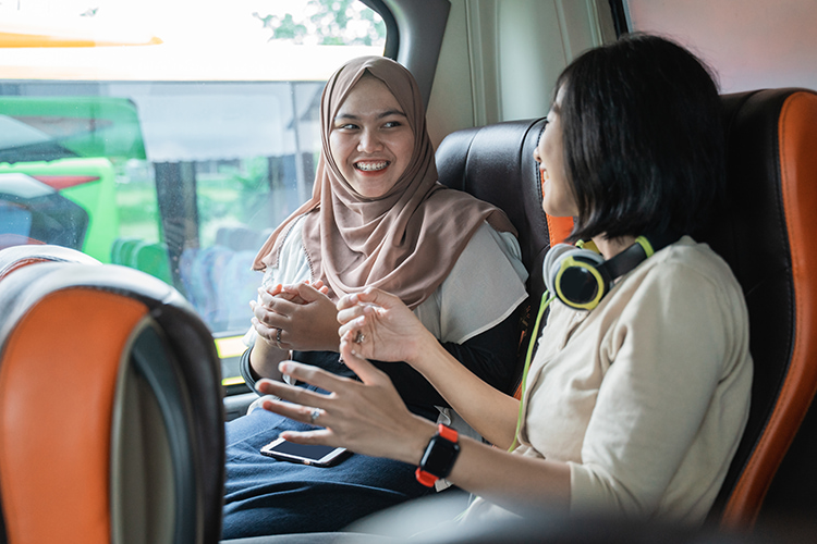 women talking on long distance bus in boston